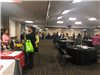People Mingle and Look at Display Tables at the Small Business Summit and Expo
